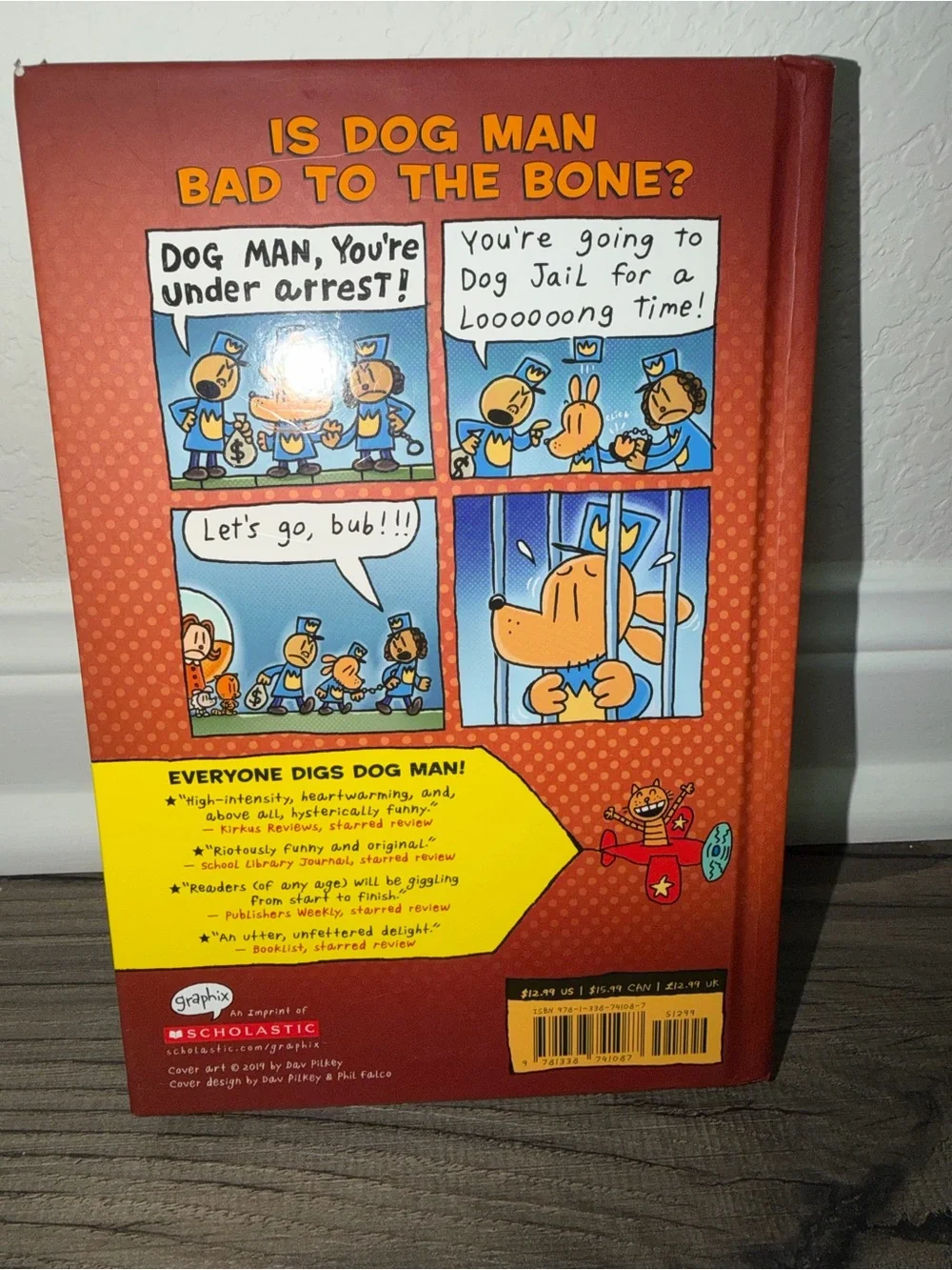 Scholastic Dog Man Hardcover with bright yellow and red cover